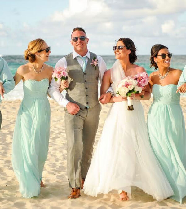 A wedding party walking on a beach in Jamaica